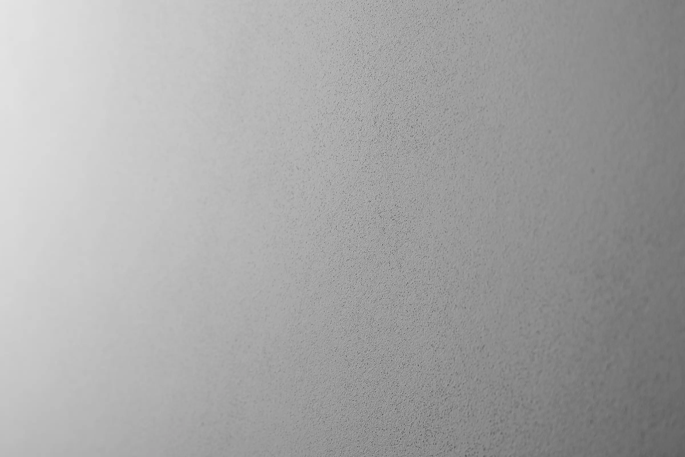 Tynk filcowany, tynk StoSignature, faktura Fine 40, drobnoziarnista szara powierzchnia tynkowana.