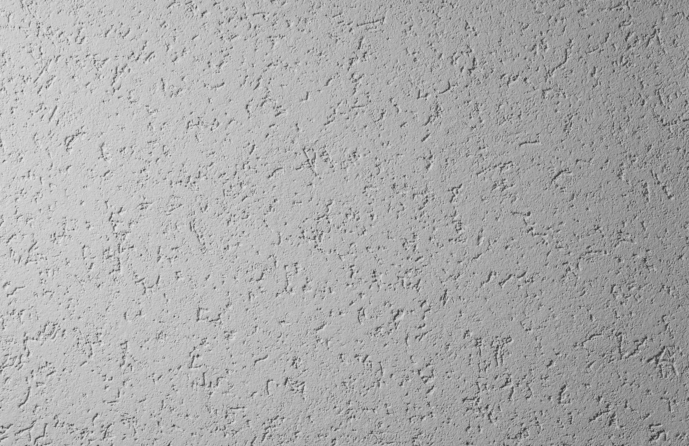 Zacierany tynk, tynk StoSignature, faktura Rough 2, szara powierzchnia.